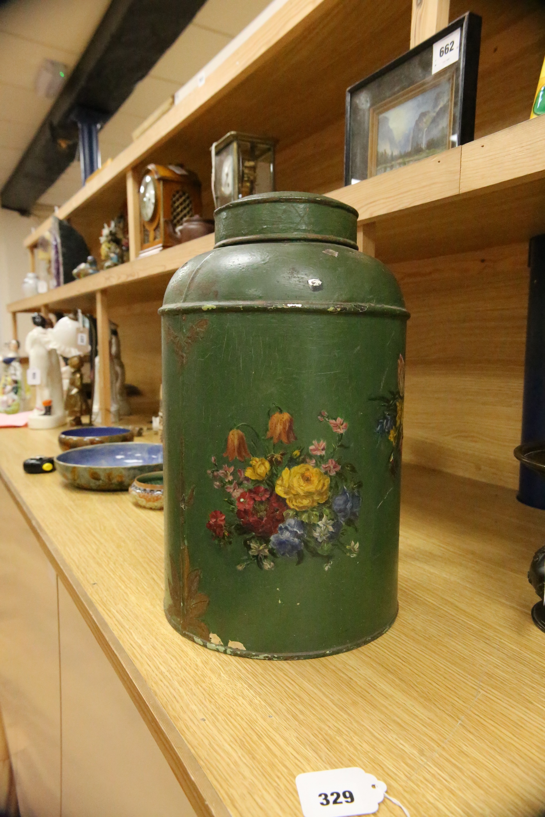 A green toleware floral decorated tea canister, 42cm high. Condition - poor, many chips to surface paint